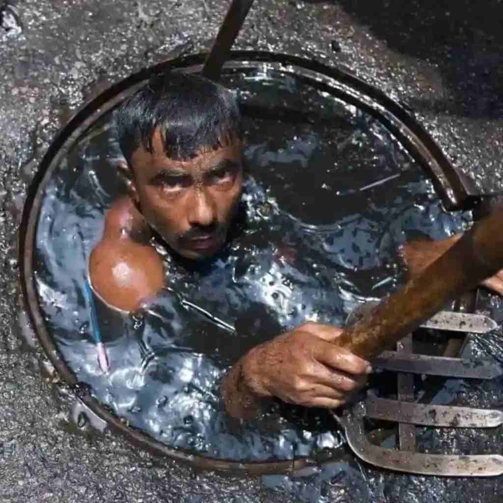man stuck in a sewer full of water